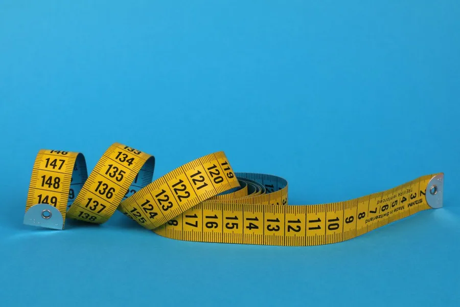 A tape measure, representing measurements and progress